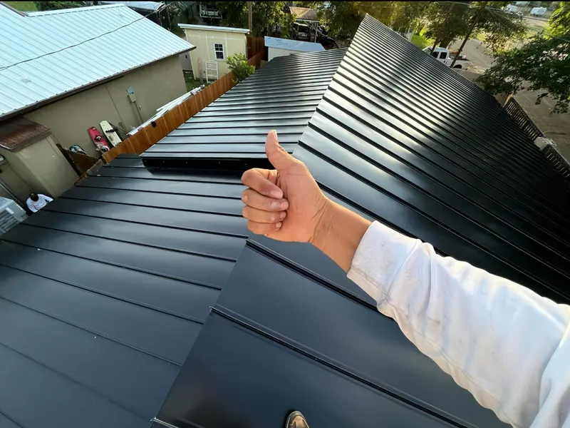 Finished black standing seam metal roof by RISE Roofing