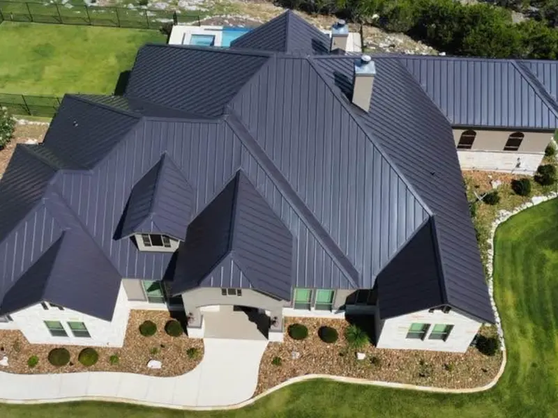 Charcoal standing seam metal roof on a large estate installed by RISE Roofing