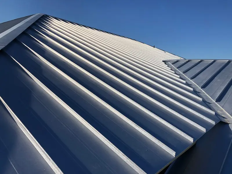 Close-up of standing seam metal roof panels showing the raised interlocking seams
