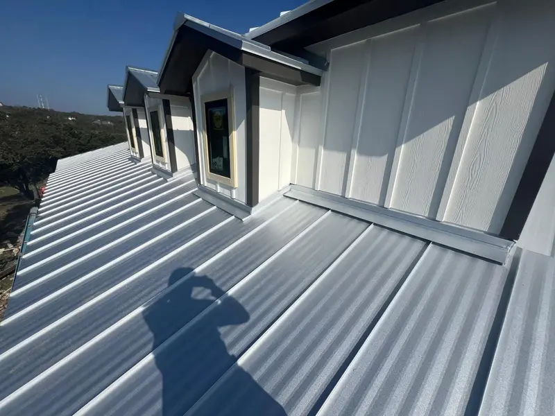 Silver standing seam metal roof on a newly built home