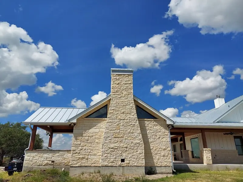 Silver standing seam metal roof installed by RISE Roofing