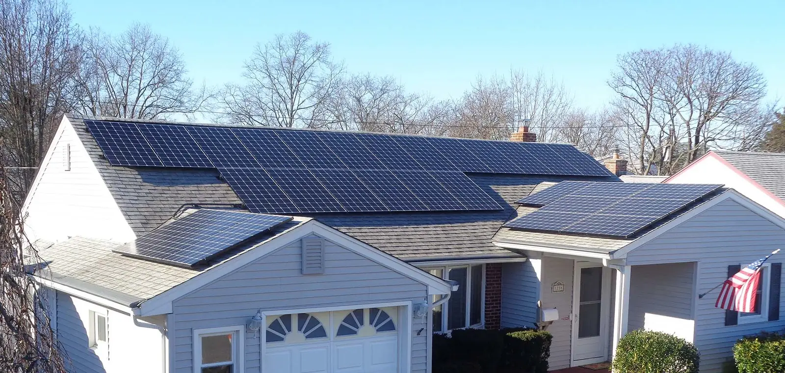 Conventional solar panels on a shingle roof Conventional solar panels mounted on the asphalt shingle roof of a single-story house